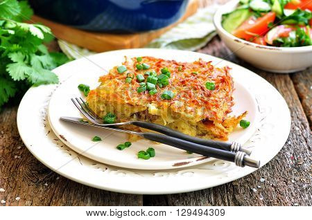 Potato - Kugel Casserole. Jewish cuisine. wooden table