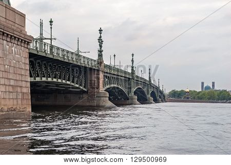 Kamennoostrovsky bridge over the river Neva in St. Petersburg with Muslim mosque and Orthodox chapel in the background.