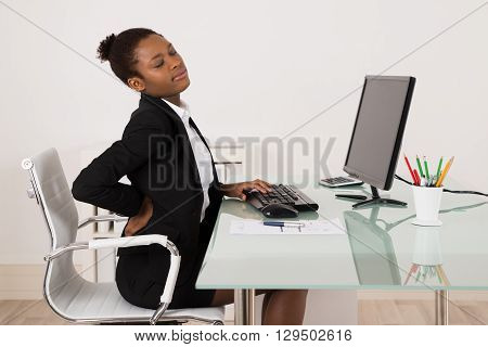 Young African Businesswoman Suffering From Backache While Working In Office