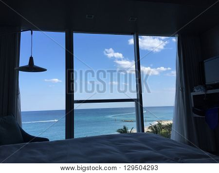 An ocean view room with a large window.