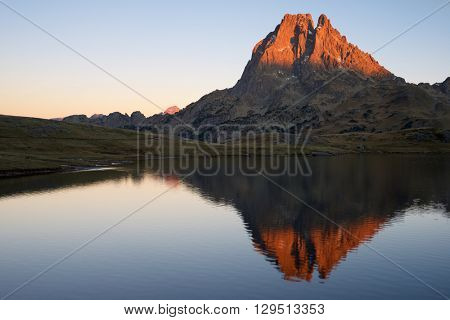 Midi Dossau Peak reflected in Ayous lake. Ossau Valley, Pyrenees National Park, Pyrenees, France.