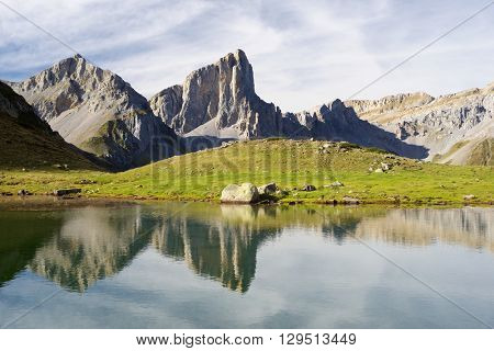 Peaks reflected in Ansabere Lake. Lescun Cirque. Aspe Valley, Pyrenees, France.