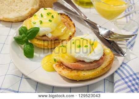 Eggs Benedict- toasted English muffins, ham, poached eggs, and delicious buttery hollandaise sauce