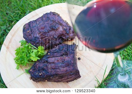 BBQ steak. Barbecue grilled beef steak meat with red wine. Healthy food. Barbeque steak dinner