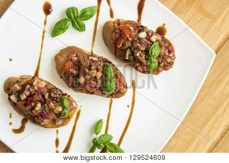 bruschetta with tomato and basil on wooden table