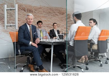 business people group brainstorming on meeting and businessman presenting ideas and projects oon laptop and tablet computer