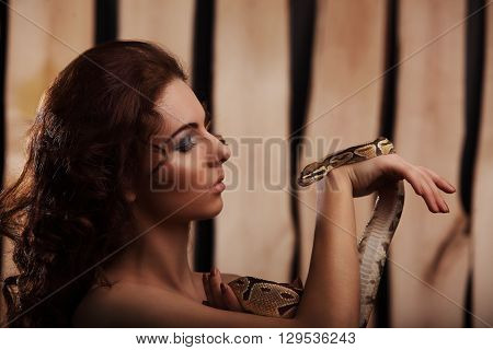 Sexy Brunette Girl With Orange Python Around Her Neck