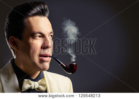 Imposing mature man with a haircut in the style of the 60s.