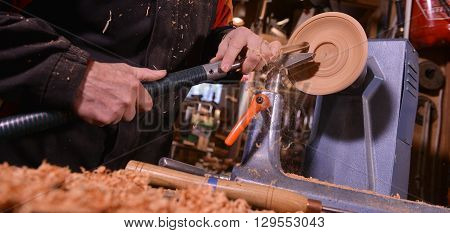 Woodturners Using A Rotating Clamp To Turn The Wood.