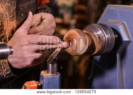 Woodturners Using A Rotating Clamp To Turn The Wood.