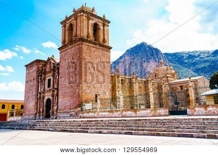 Bell Tower of Pupuka Church in Pukara with ceramic cow at the fence in Peru