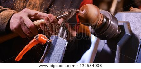 Woodturners Using A Rotating Clamp To Turn The Wood.