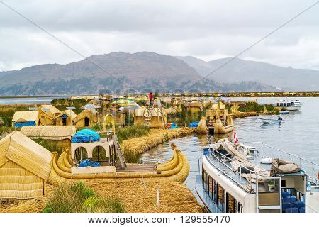 View at the Floating Island Los Uros with typical boats in Lake Titicaca Puno Peru