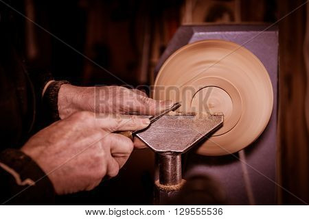 Woodturners Using A Rotating Clamp To Turn The Wood.