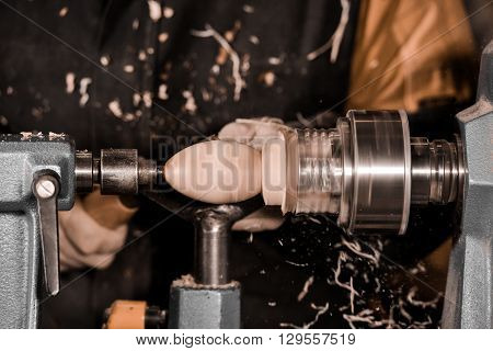 Woodturners Using A Rotating Clamp To Turn The Wood.
