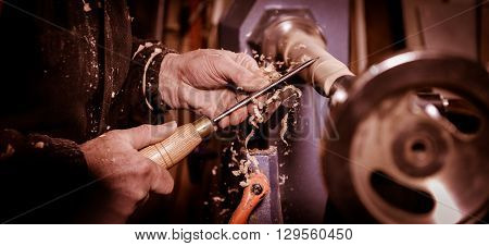 Woodturners Using A Rotating Clamp To Turn The Wood.