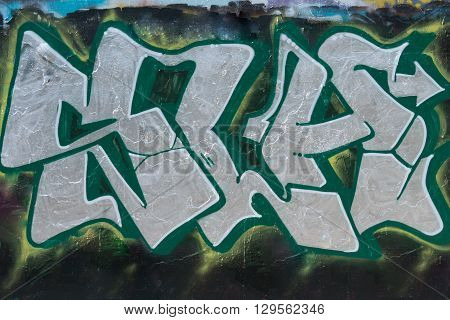 Wall painted grafitti, green with silver letters
