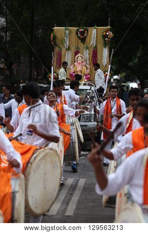 Pune India - September 17 2015: Ganesh festival procession being traditionally celebrated Dhol Tasha percussion and dancing.