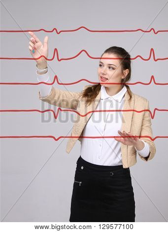 Doctor woman working with cardiogram lines