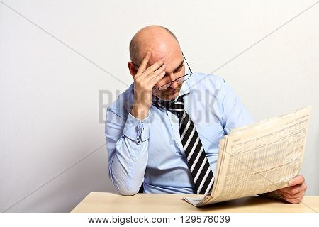 Manager Studies The Financial Part Of A Newspaper.