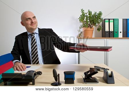 Boss handed over a folder. He is smiling.