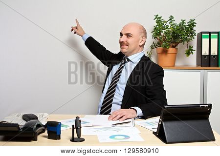 Manager presents the new sales figures while pointing on something