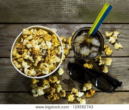 Popcorn and cola on the black background