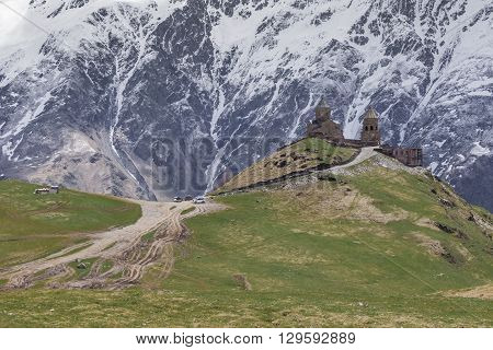 Georgia Stepantsminda-Sameba. Ancient Gergeti Trinity Church high in the mountains.