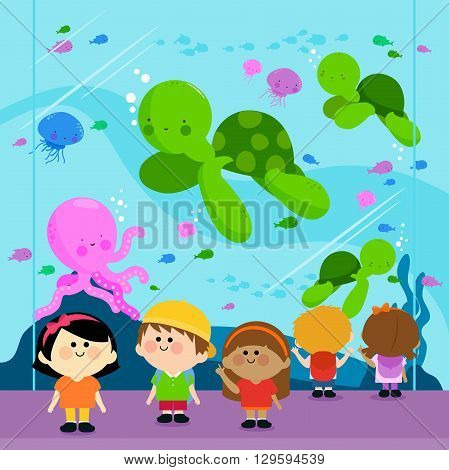 Group of children visiting the oceanarium and looking at the sea animals
