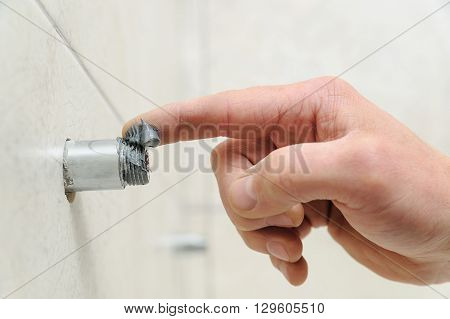 Plumber putting a paste sealant on the threads pipe.