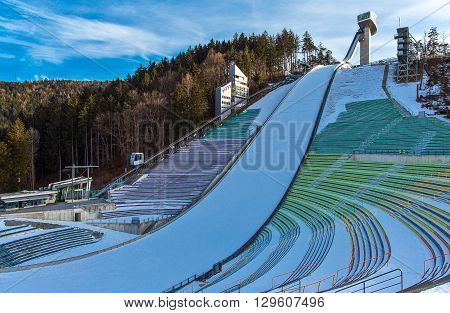 Innsbruck Austria - February 8 2010: The snowy Bergisel skijamping stadium at sunset
