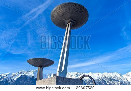 Innsbruck Austria - February 8 2010: The braziers of the Bergisel skijamping stadium with the snowy mountains in the background