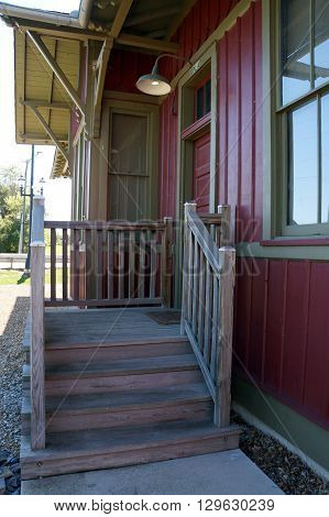 PLAINFIELD, ILLINOIS / UNITED STATES - SEPTEMBER 20, 2015: A wooden stairway leads to the entrance to the old Plainfield Depot, which now serves as a museum operated by the Plainfield Historic Preservation Commission.