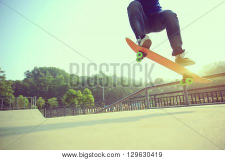 young skateboarder skateboarding at outdoor skate park