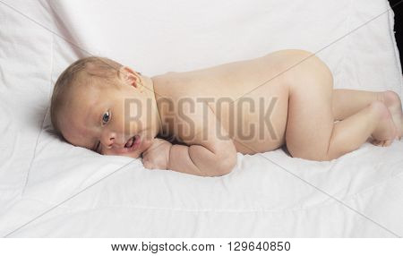 New Born baby on his towl isloated inside studio