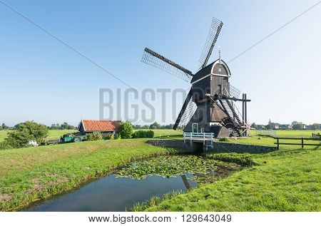 Back side of a polder mill in the Dutch village of Streefkerk which was built before the year 1751; now no longer in use as such but still capable to grind.