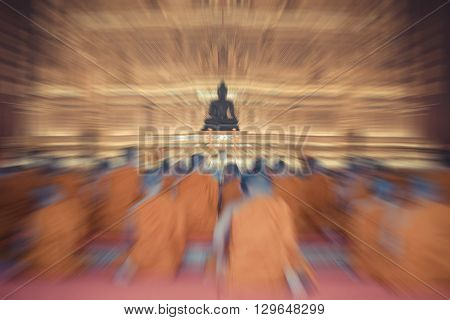 Blurred zoom of Thai monk worship in temple at Wat Thep Sirin Thrawat Ratchaworawihan. process in vintage style