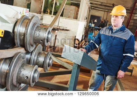 industrial factory worker with tube bending machine