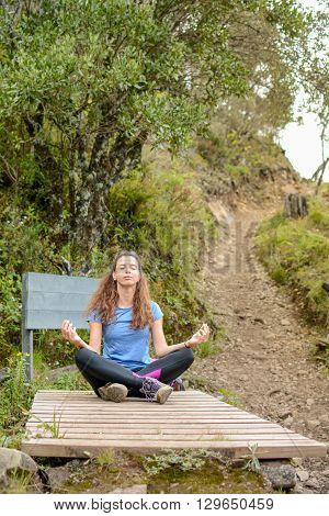 female hiker doing yoga on hiking trip
