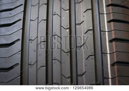 Car tires close-up Winter wheel profile structure on black background