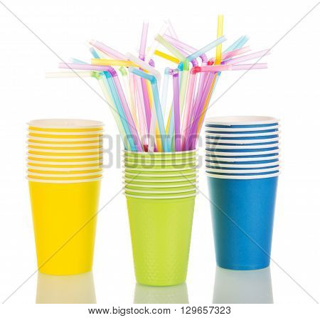 Multi-colored paper cups and cocktail straws isolated on white background
