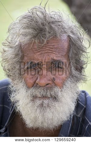 MATARA SRI LANKA - NOVEMBER 5 2014: Unidentified old Sri Lankan beggar waits for alms on a street next to the bus station