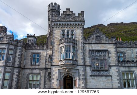 Calway Ireland - August 4 2013: Connemara area upward view of the Kylemore abbey on the Pollacappul lake