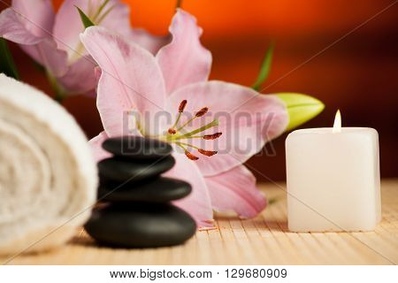 towel flowers and massage rocks set up on a table in wellnes center