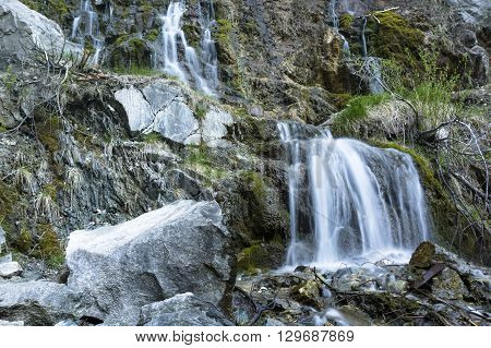 Waterfall at talc quarry among the mossy stones