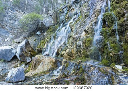 Waterfall at talc quarry among the mossy stones