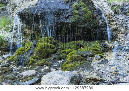 Waterfall at talc quarry among the mossy stones