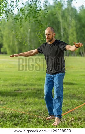 Man practising slack line in the park