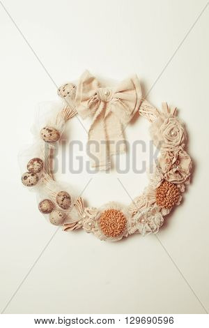 Easter wreath with white bow on the front door isolated on white