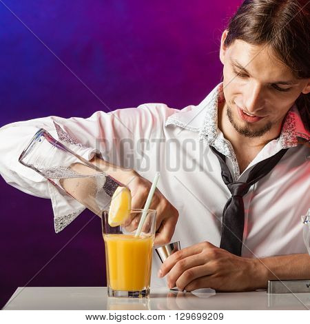 Alcohol liquor drinking party relax bartending concept. Young bartender pouring beverages. Male barman prepares cocktail in glass shaker.